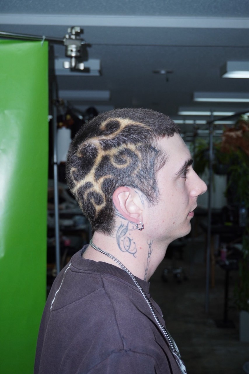 Leopard pattern shaved into a fade, seen in profile