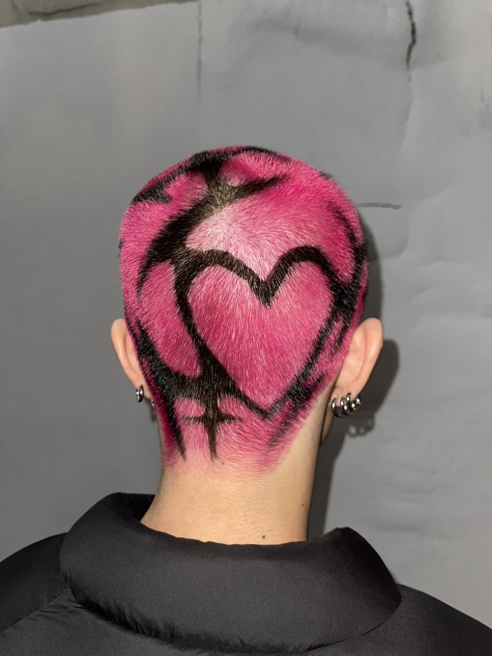 Heart design shaved into pink hair, seen from behind